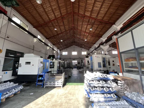 Workshop interior with machining equipment and components in the foreground